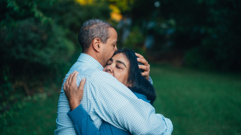 Two persons hugging